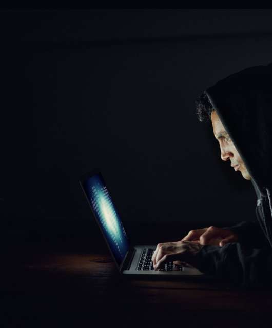 man-hacker-on-laptop-spoofing